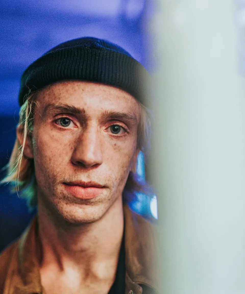 Young man in a beanie in blue evening light