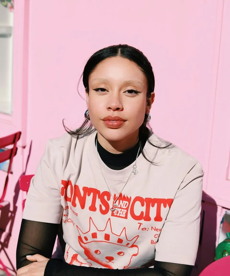 Young woman in a streetwear T-shirt looking into the camera